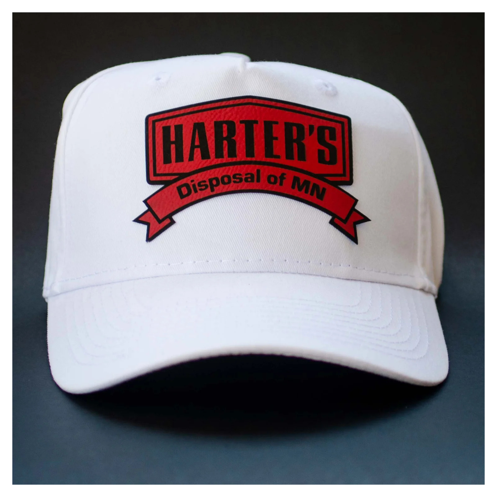 white twill baseball cap with red black faux leather patch heat transfer from Apex Transfers
